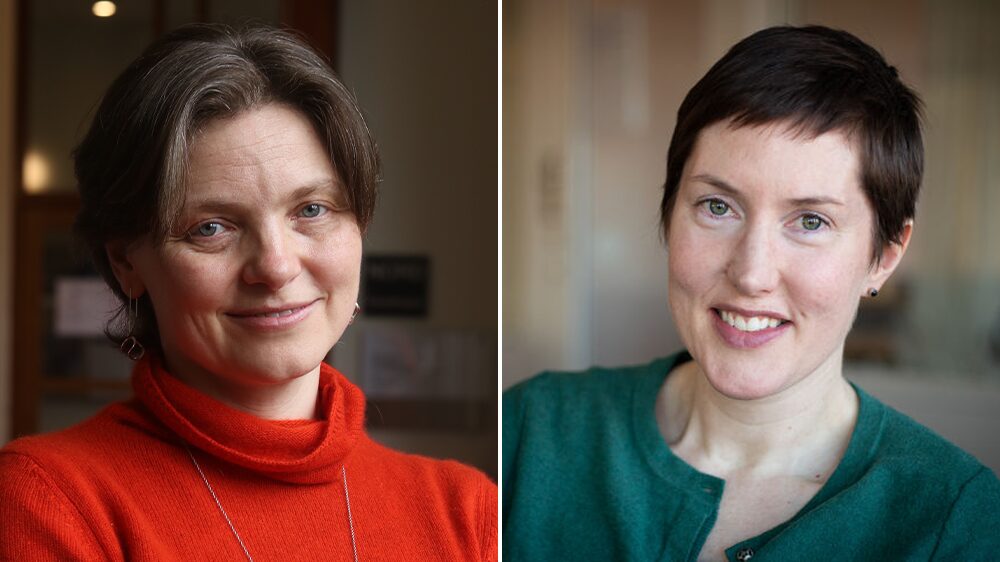 Two women looking into the camera and smiling. The one to the left in a red shirt, and the one to the right in a green shirt.