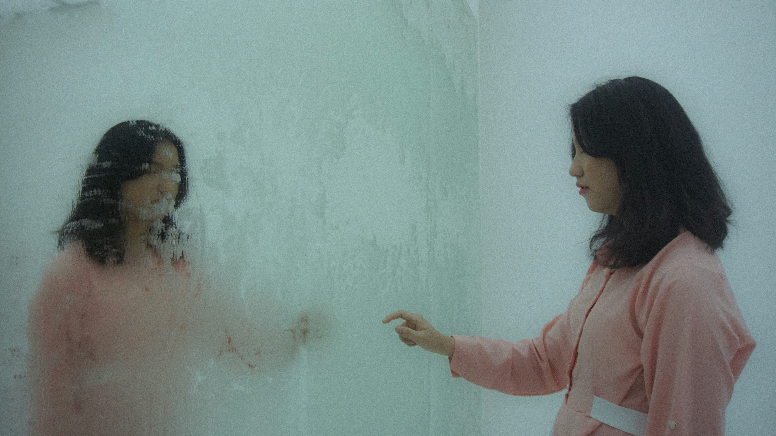 Girl in mirror looking at her blurred reflection